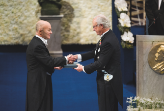 Right image: Eugene Fama, on the left, shakes hands with the man handing him the 2013 Nobel Prize in Economic Sciences.